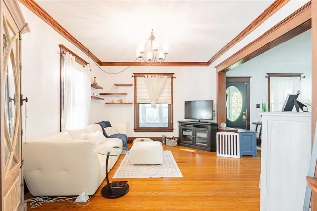 a living room with furniture window and wooden floor