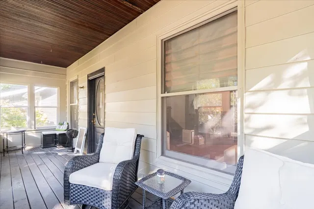 a living room with furniture and a floor to ceiling window
