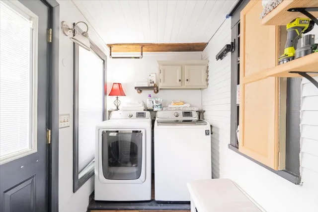 a utility room with wooden floor washer and dryer