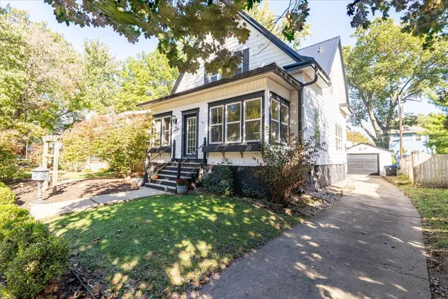 a view of a house with backyard sitting area and garden