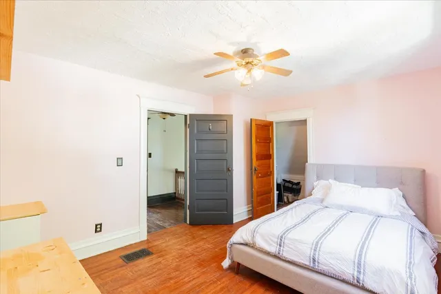 a bedroom with a bed and a chandelier