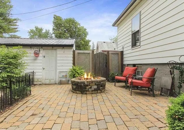 a backyard of a house with outdoor seating