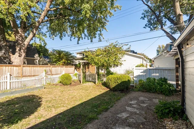 a backyard of a house with yard and outdoor seating