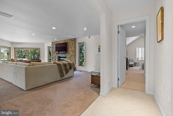 a kitchen with stainless steel appliances kitchen island granite countertop a sink and a refrigerator