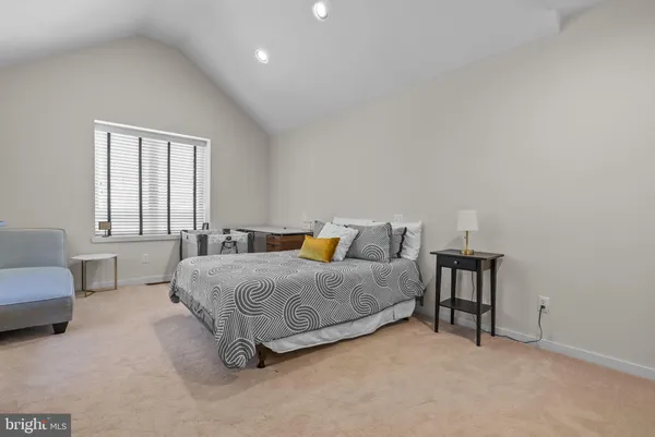 a kitchen with stainless steel appliances granite countertop a sink a stove a refrigerator cabinets and chairs
