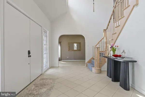 a view of a room that has a bed and a table in it