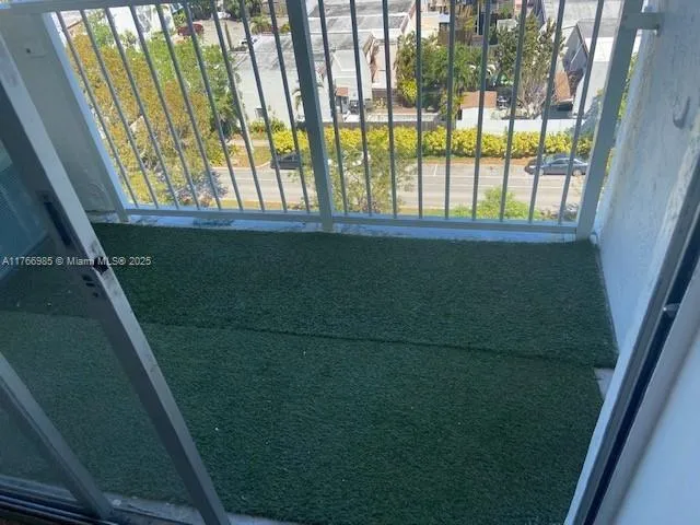 a view of a glass door with a roof deck