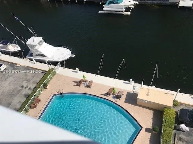 a kitchen with a refrigerator a stove and wooden floor
