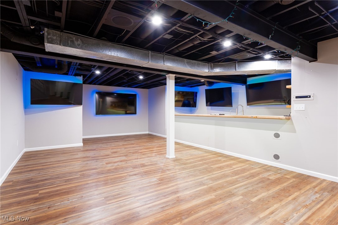 14566 West Ridge Road Novelty, OH 44072 - Photo 42 of 49 Finished basement with baseboards and wood finished floors