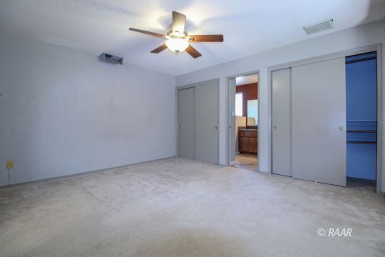 636 Heather Court Ridgecrest, CA 93555 - Photo 23 of 33 an empty room with closet and a ceiling fan