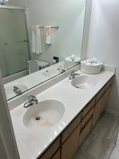 a bathroom with a double vanity sink and a mirror
