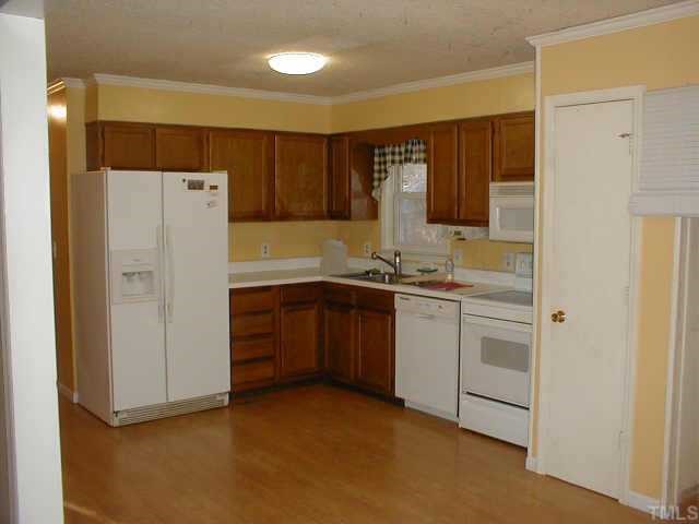 263 Pea Ridge Road New Hill, NC 27562 - Photo 6 of 7 a kitchen with a refrigerator and a sink