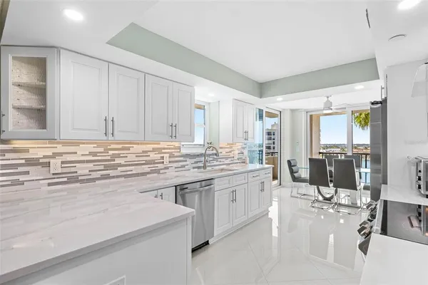 a kitchen with stainless steel appliances a refrigerator sink and cabinets
