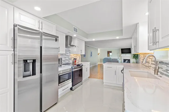 a kitchen with a stove and white cabinets