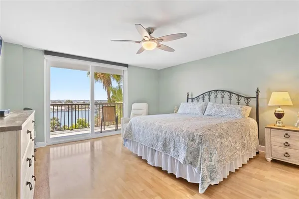 a bedroom with a large bed and a chandelier