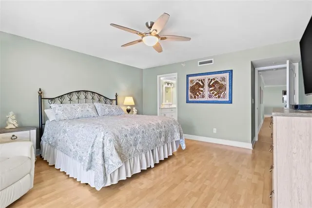 a bedroom with a bed tv and a window