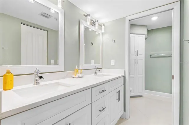 a bathroom with a shower and a glass door