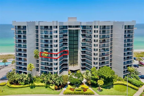 a front view of a building with garden space and street view