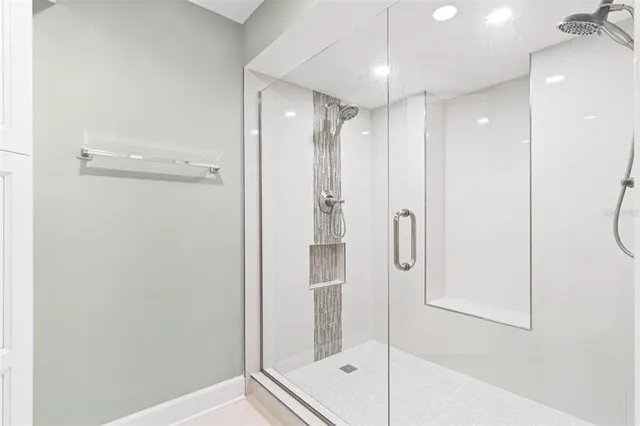 a white toilet sitting next to a shower