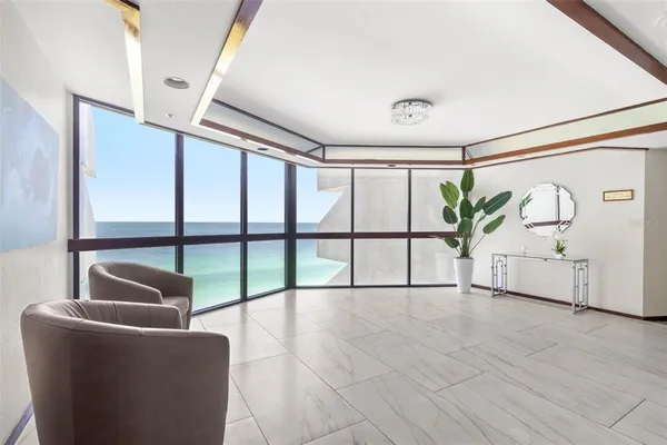 a living room with furniture and a chandelier