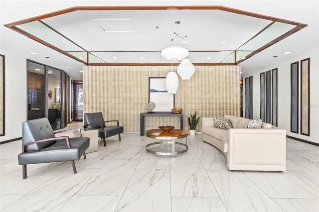 a living room with furniture and a floor to ceiling window