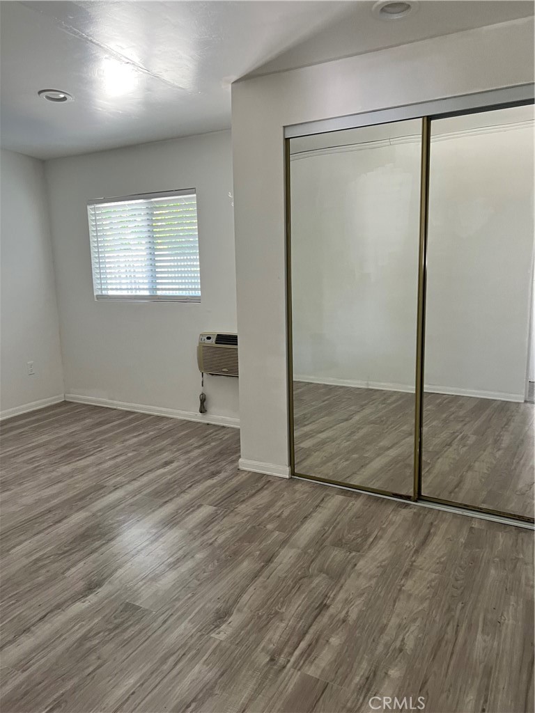 4731 Helmgate Drive El Monte, CA 91732 - Photo 14 of 30 an empty room with wooden floor and mirror