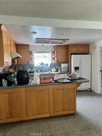 a kitchen with a sink a stove and cabinets
