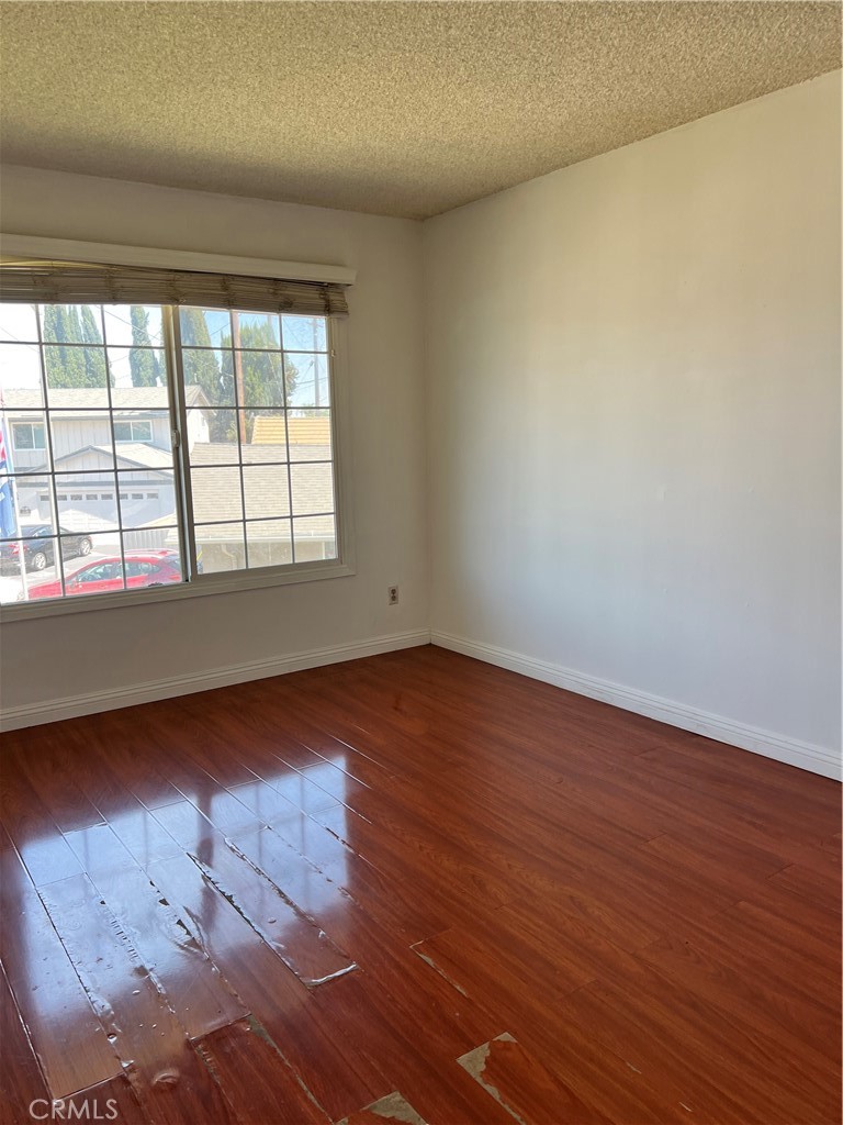 4731 Helmgate Drive El Monte, CA 91732 - Photo 23 of 30 an empty room with wooden floor and windows