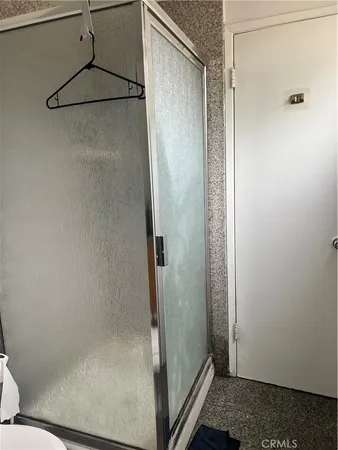 a bathroom with a glass shower door