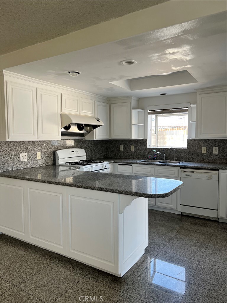 4731 Helmgate Drive El Monte, CA 91732 - Photo 4 of 30 a large kitchen with granite countertop a sink a stove and cabinets