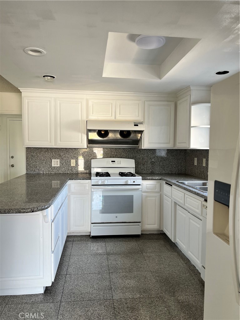4731 Helmgate Drive El Monte, CA 91732 - Photo 5 of 30 a kitchen with granite countertop white cabinets and white appliances
