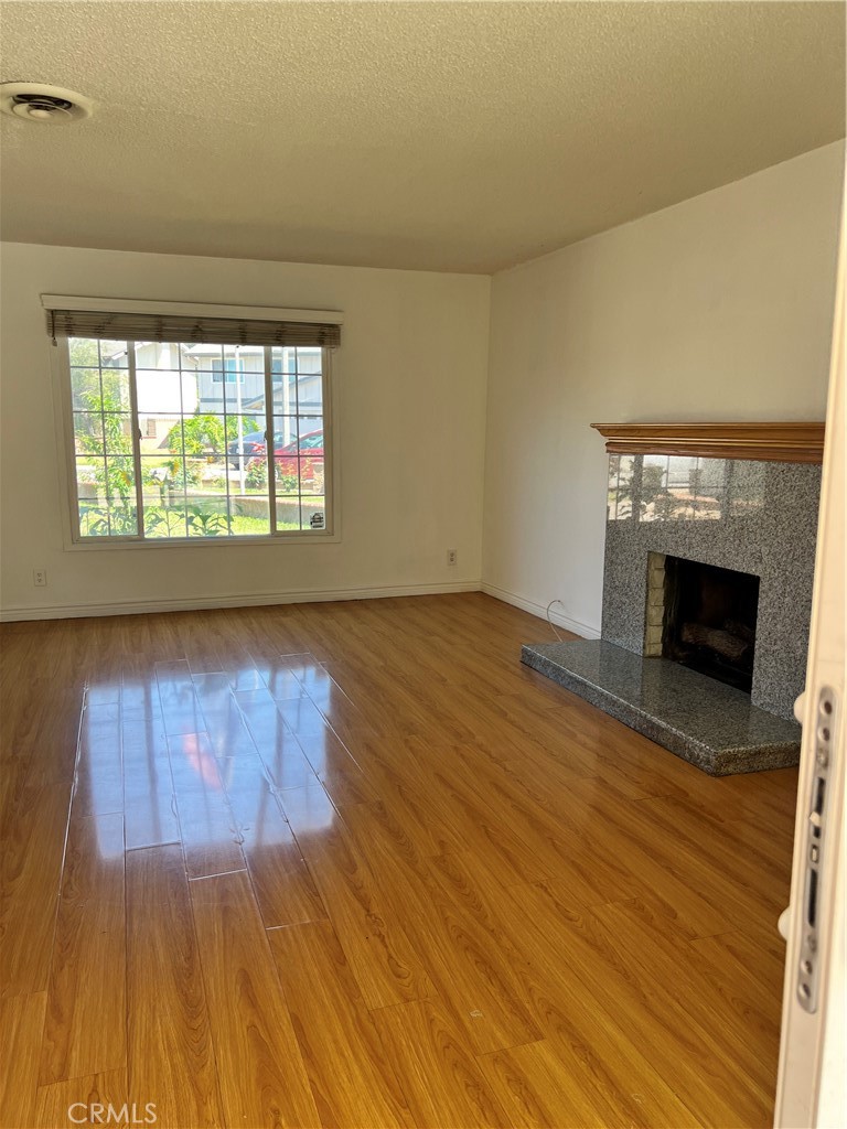 4731 Helmgate Drive El Monte, CA 91732 - Photo 8 of 30 an empty room with wooden floor fireplace and windows