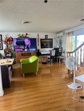a room with lots of chairs and wooden floor