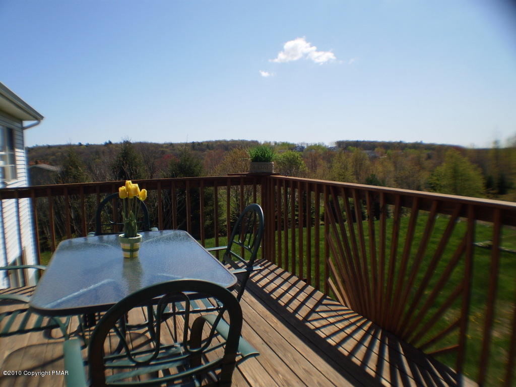 2247 State Road Effort, PA 18330 - Photo 6 of 16 a view of a balcony with wooden floor and outdoor seating
