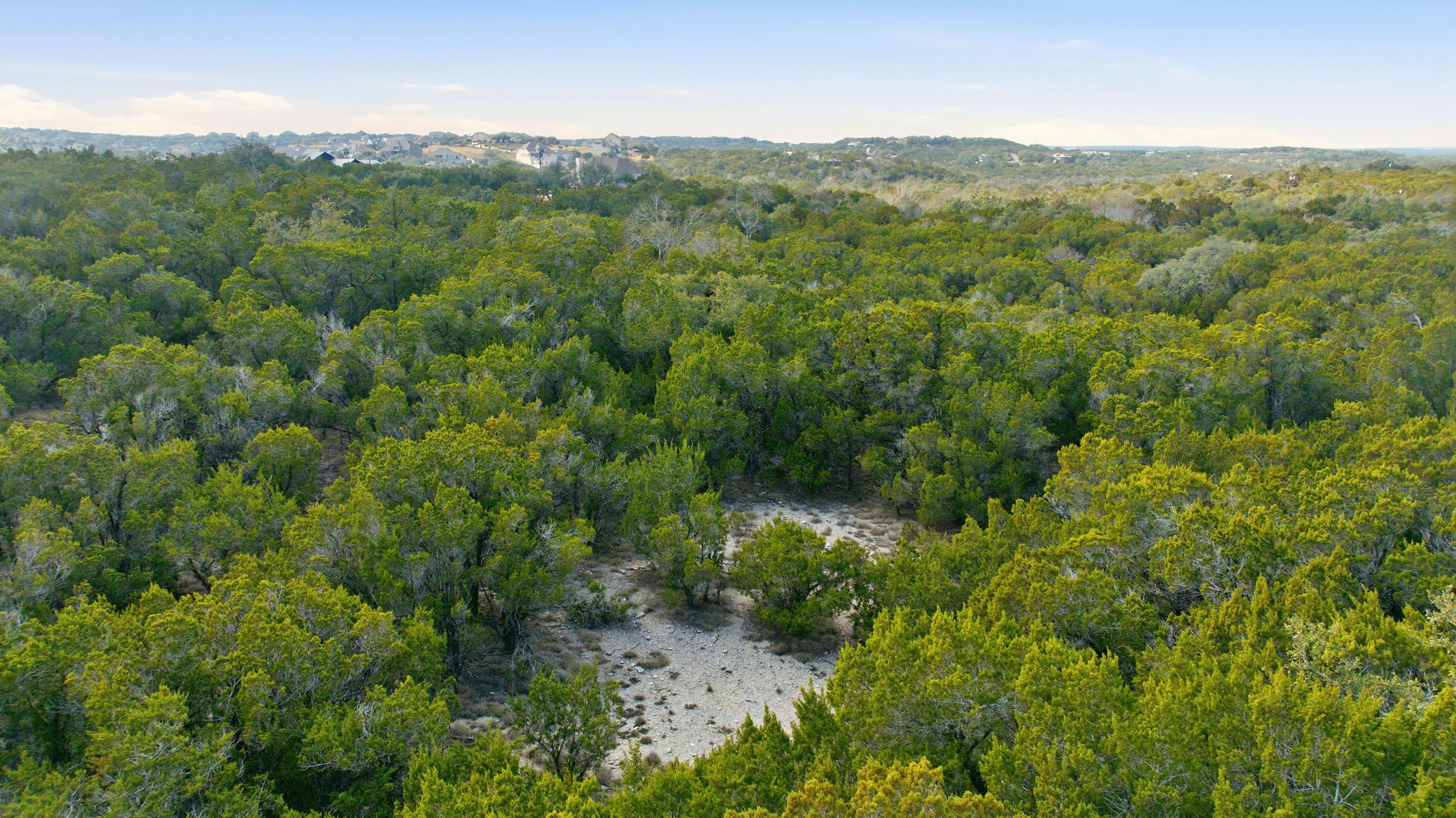 400 Sundown Ridge Austin, TX 78737 - Photo 21 of 21 View of property location with a heavily wooded area