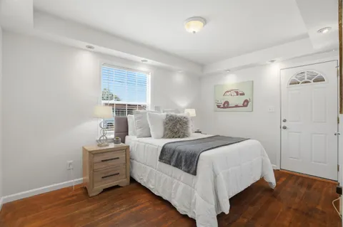 a bedroom with a bed and a painting
