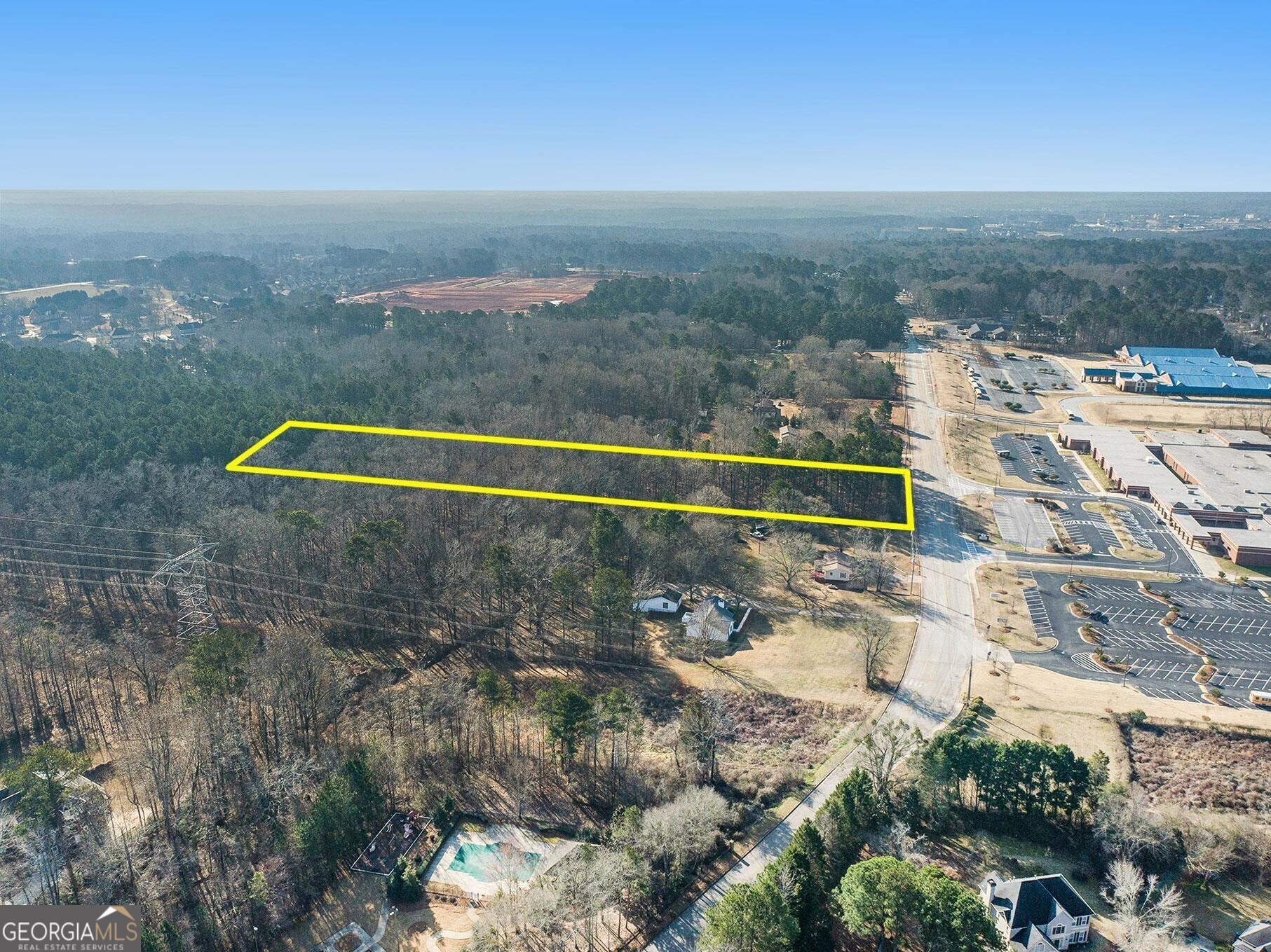 0 Tunis Road McDonough, GA 30253 - Photo 5 of 6 a view of a lake with a building in the background