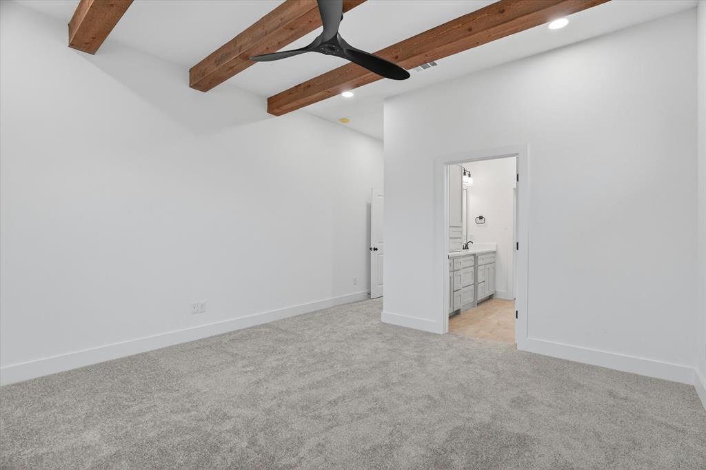 225 Kilkenny Road Poolville, TX 76487 - Photo 16 of 36 Spacious room featuring exposed wood ceiling beams and a contemporary black ceiling fan