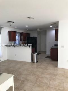 15280 Northeast 34th Terrace Citra, FL 32113 - Photo 16 of 37 a kitchen with stainless steel appliances kitchen island granite countertop a refrigerator oven a sink a counter top space and cabinets
