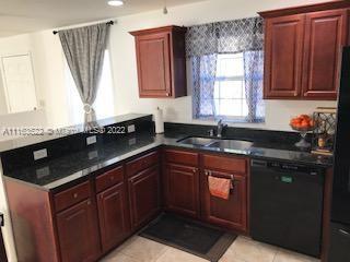 15280 Northeast 34th Terrace Citra, FL 32113 - Photo 23 of 37 a kitchen with granite countertop a sink a window stainless steel appliances and cabinets