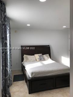 15280 Northeast 34th Terrace Citra, FL 32113 - Photo 27 of 37 a bedroom with a bed and a night stand