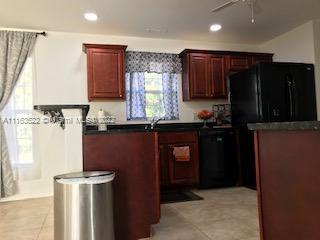 15280 Northeast 34th Terrace Citra, FL 32113 - Photo 28 of 37 a kitchen with a sink a refrigerator and cabinets