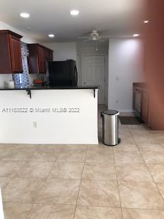 15280 Northeast 34th Terrace Citra, FL 32113 - Photo 29 of 37 a view of kitchen with stainless steel appliances granite countertop a refrigerator and a wooden cabinets