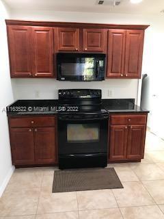 15280 Northeast 34th Terrace Citra, FL 32113 - Photo 31 of 37 a kitchen with granite countertop a stove and a microwave