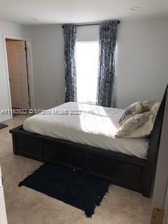 15280 Northeast 34th Terrace Citra, FL 32113 - Photo 34 of 37 a bedroom with a bed and a mirror