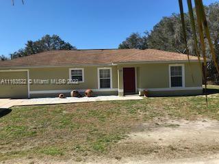 15280 Northeast 34th Terrace Citra, FL 32113 - Photo 5 of 37 a front view of a house with a yard
