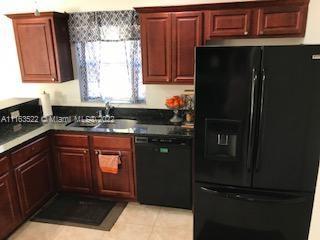 15280 Northeast 34th Terrace Citra, FL 32113 - Photo 7 of 37 a kitchen with a refrigerator and a sink