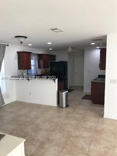 15280 Northeast 34th Terrace Citra, FL 32113 - Photo 10 of 37 a kitchen with stainless steel appliances kitchen island granite countertop a refrigerator and a sink
