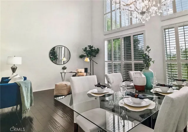 a living room with furniture a window and a chandelier