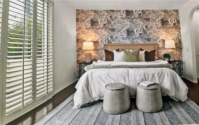 a bedroom with a bed and wooden floor